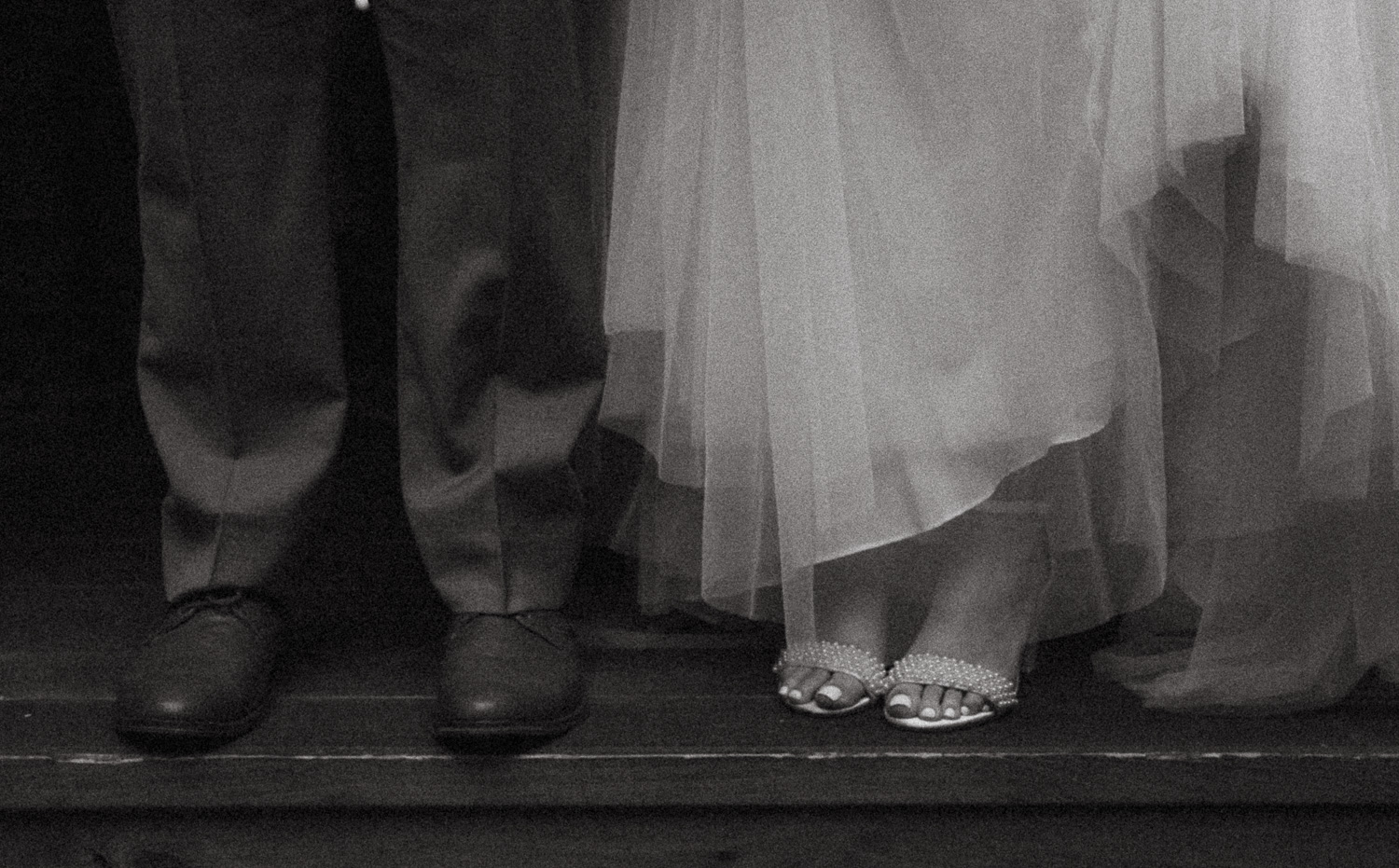 An Asheville elopement couple where showing off their footwear in a black and white image