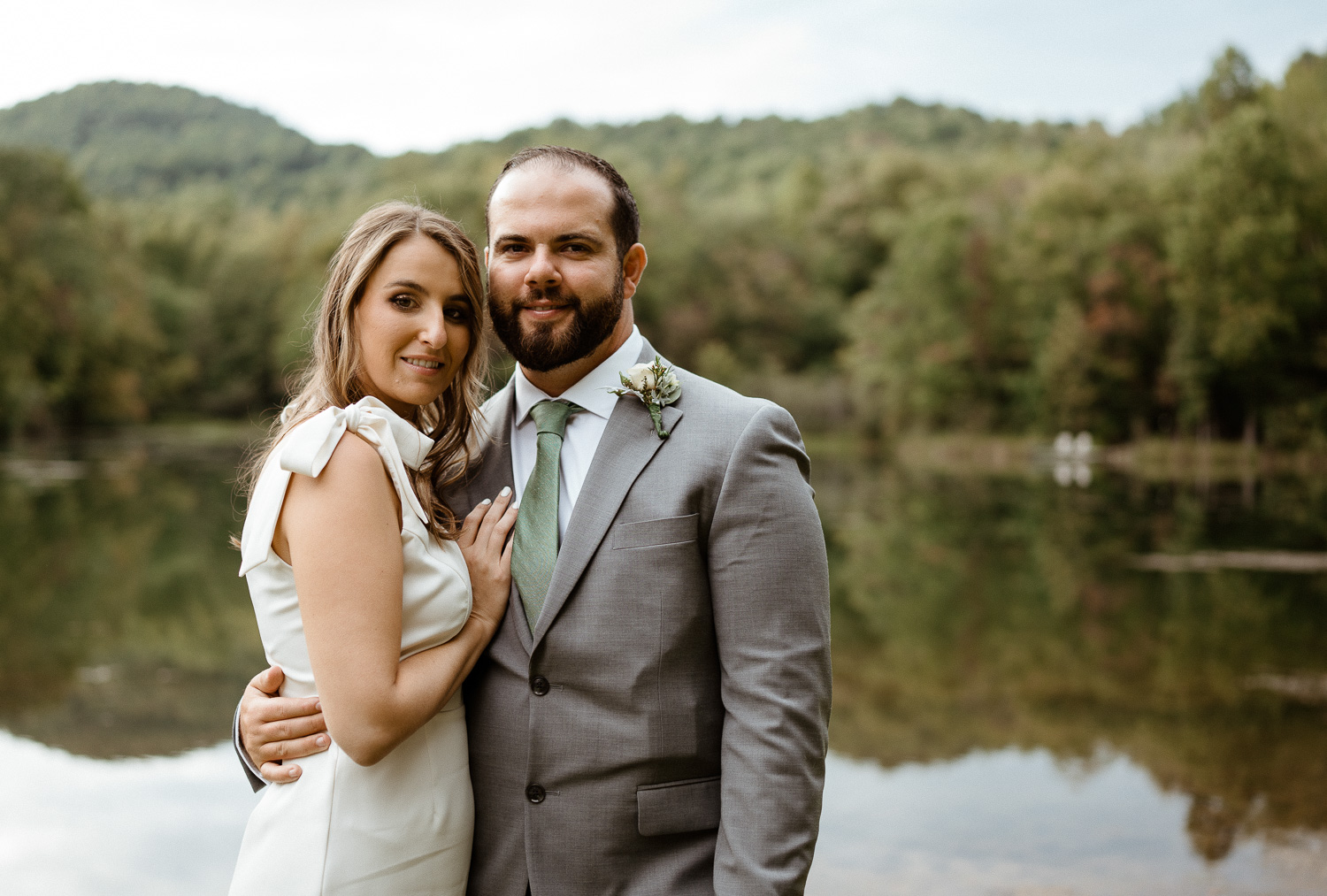 Couple pose in front of Lake on their Asheville elopement day