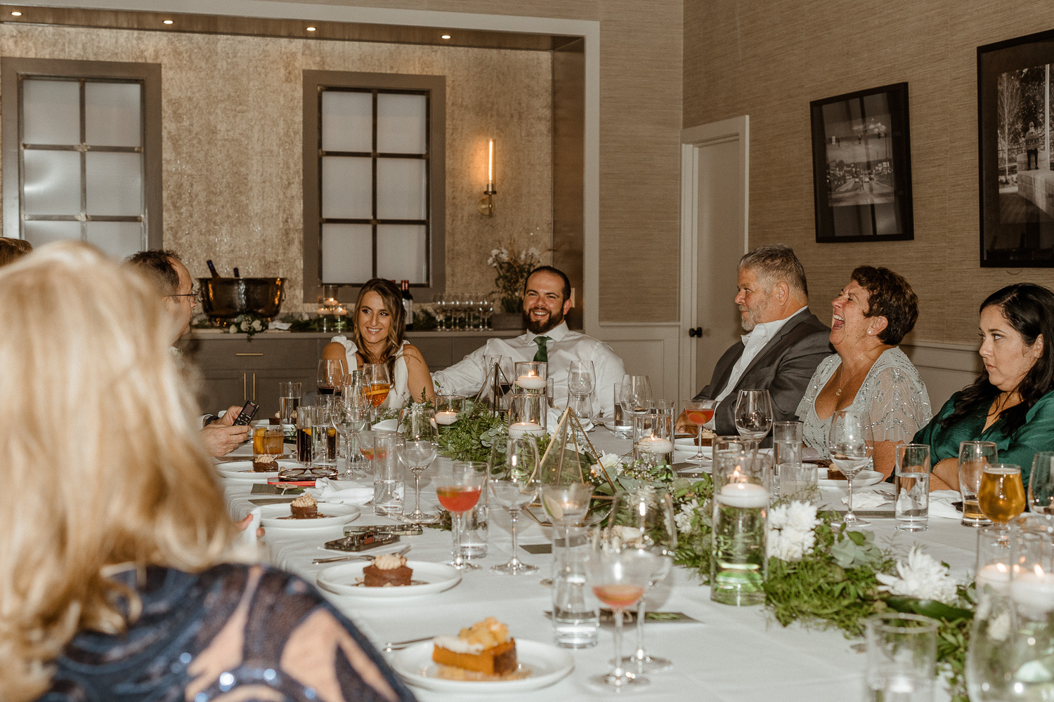 The guests laugh during speeches from the parents after the Asheville elopement