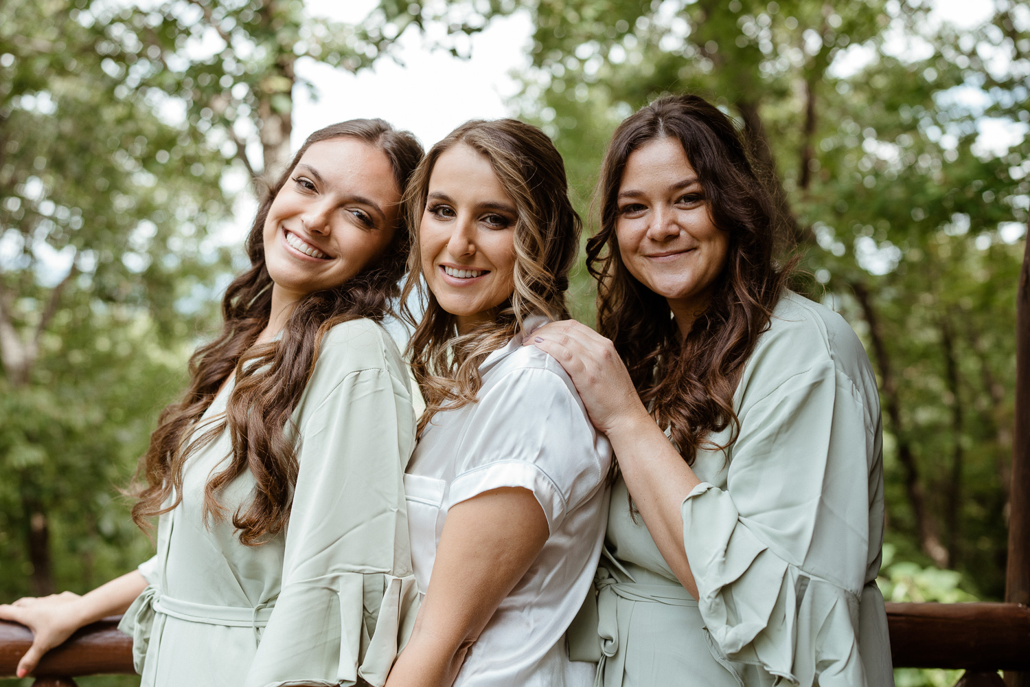 Bride and her best friends embrace while getting ready for her elopement
