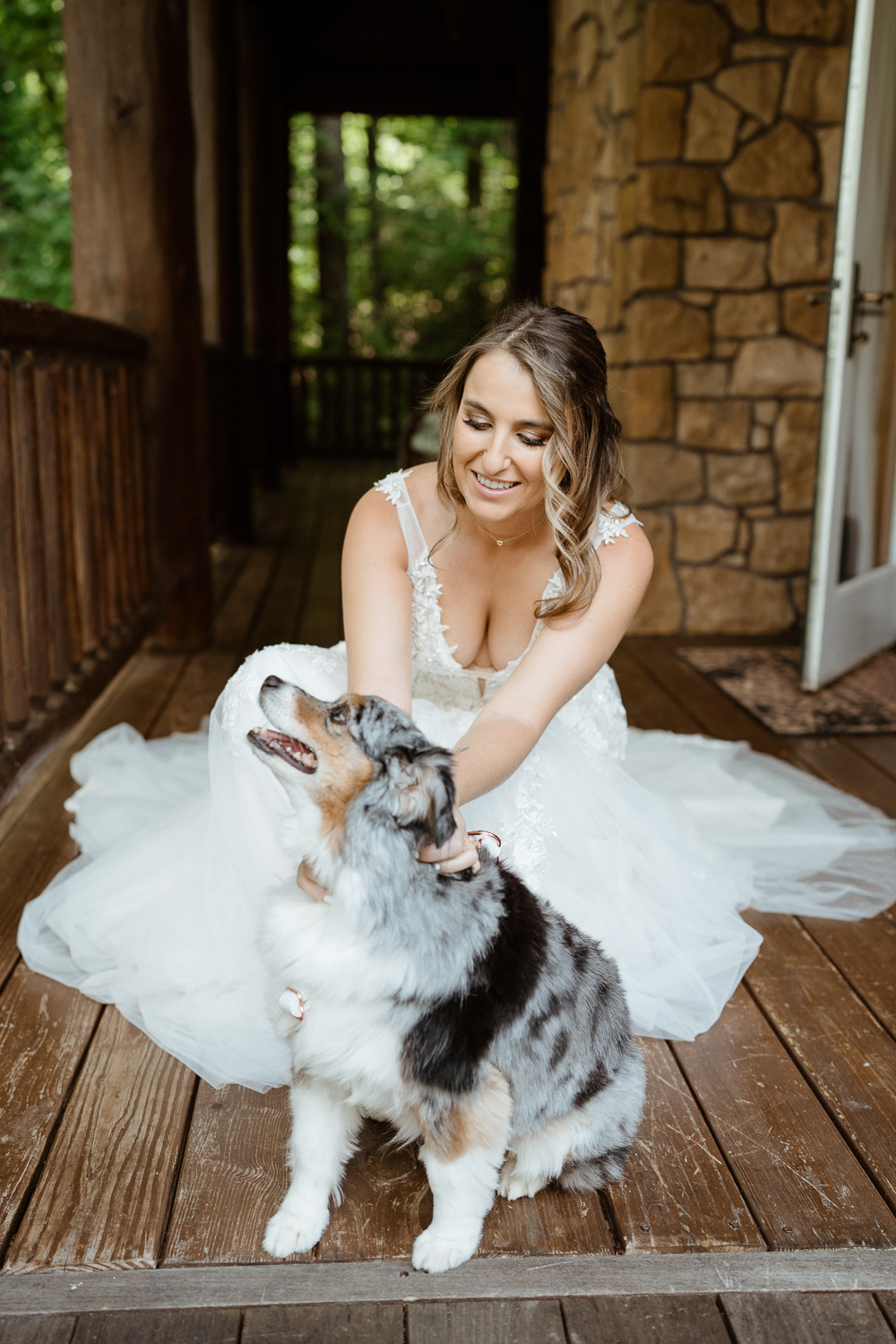 Bride pets her Australian shepherd 
